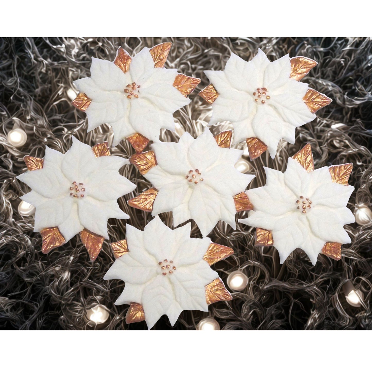 White poinsettia cupcake toppers on a Sparkly background