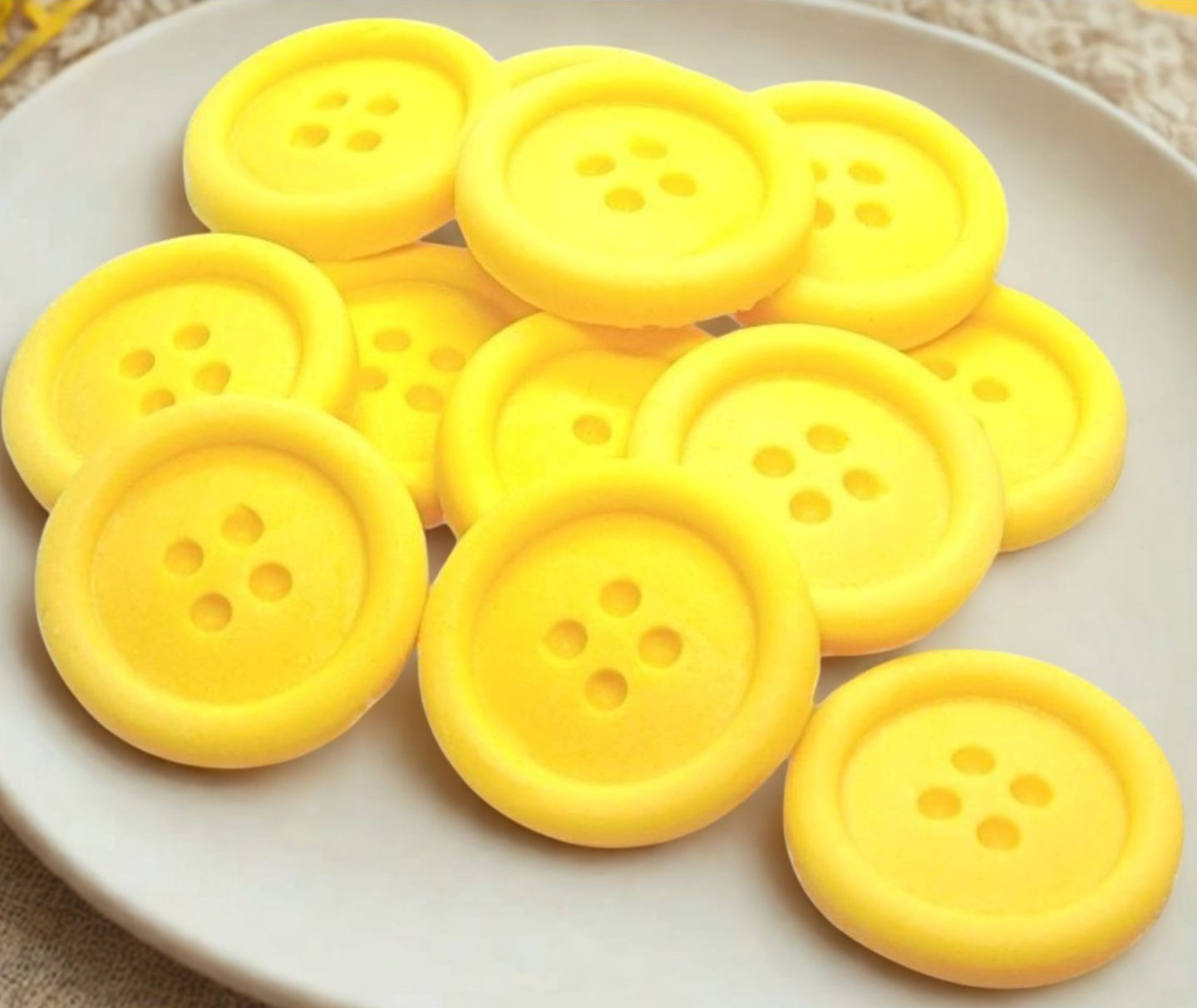 Yellow-colored shaped buttons on a white plate 