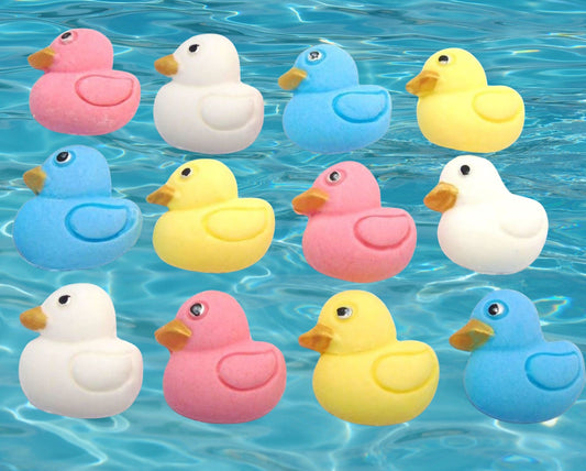 Colorful edible ducks cupcake toppers image shows them  floating on water