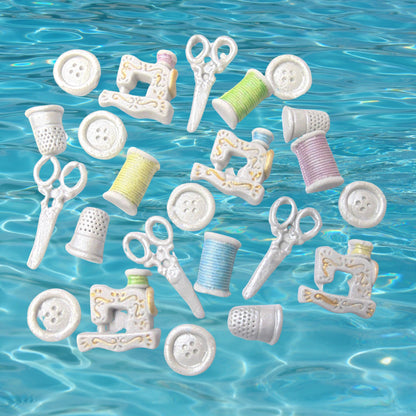 Set 24 handmade vegan sewing kit cupcake topper cake decorations on a blue background