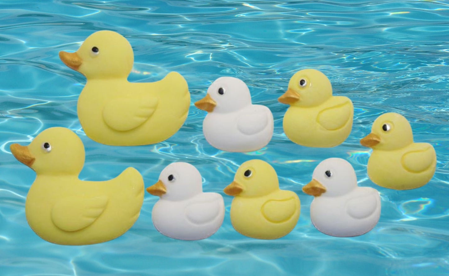 Edible Yellow and white ducks cupcake toppers shown floating on blue water