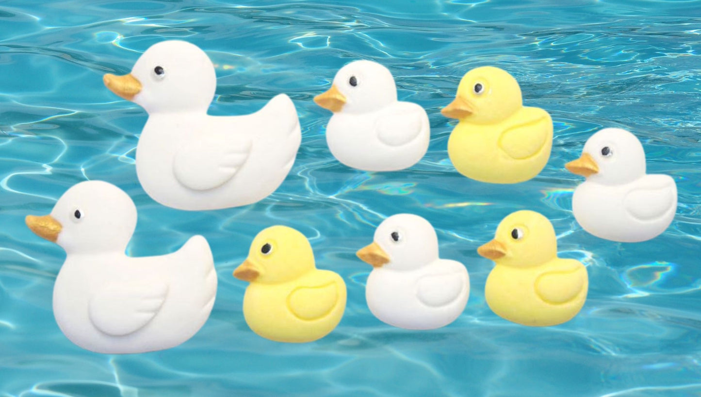 Edible White and yellow  ducks cupcake toppers shown floating on blue water
