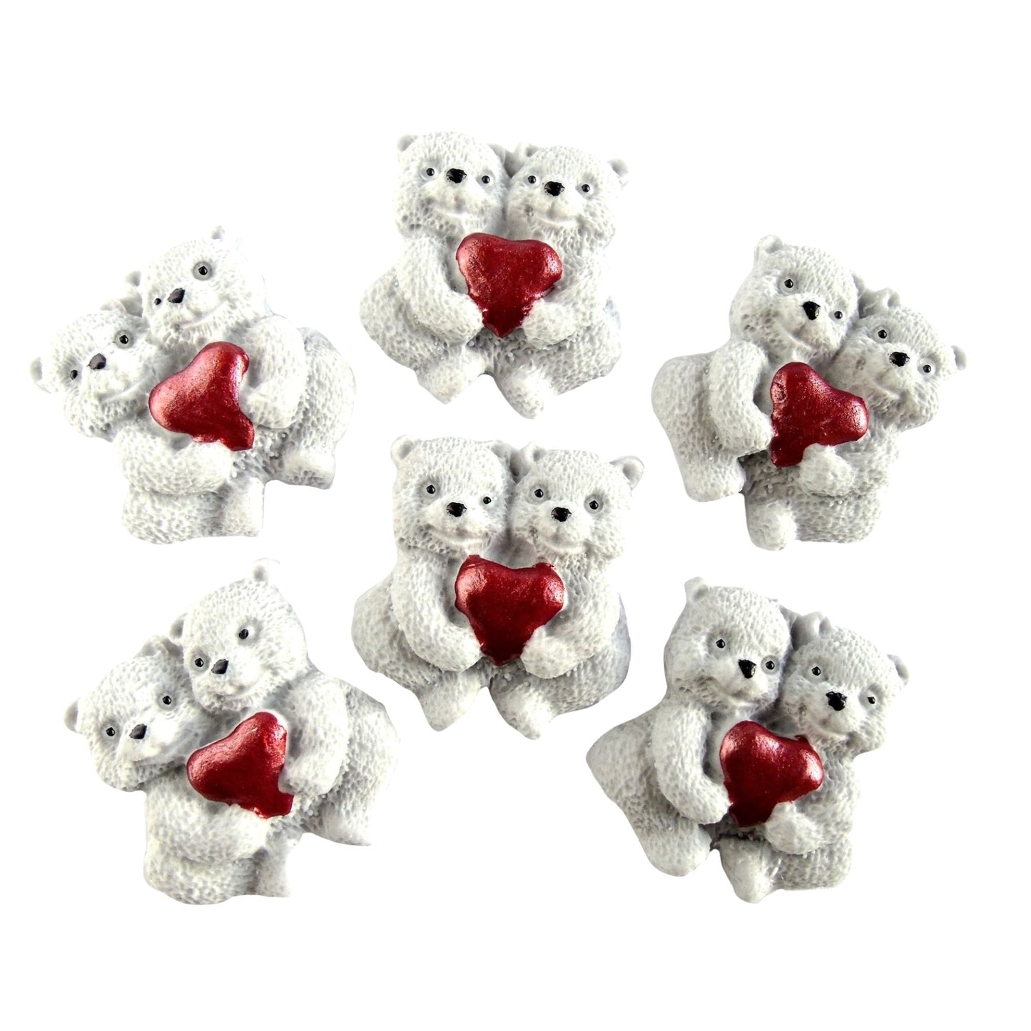 Set of six edible white  bear figurines holding red hearts on a white background