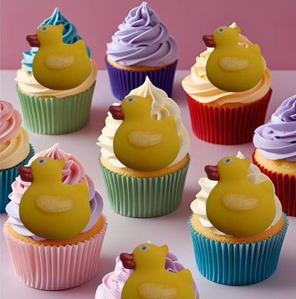 Duck cupcakes toppers on a colorful frosting on a pink background