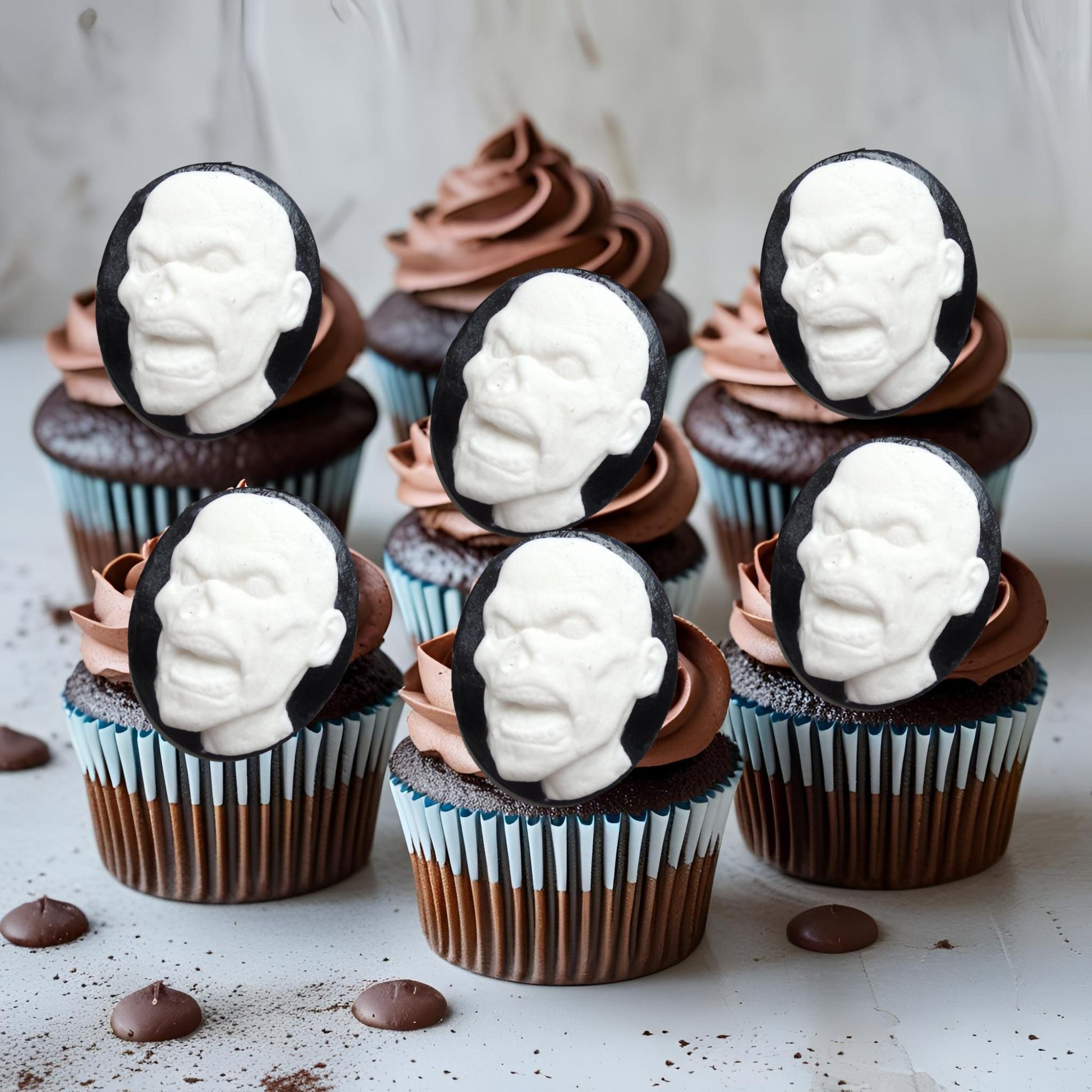 Cupcakes with white face zombies  decorations on a light background
