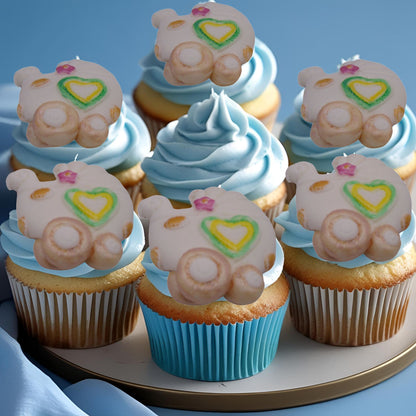 6 Chunky baby pram edible toppers sitting on blue frosted cupcakes