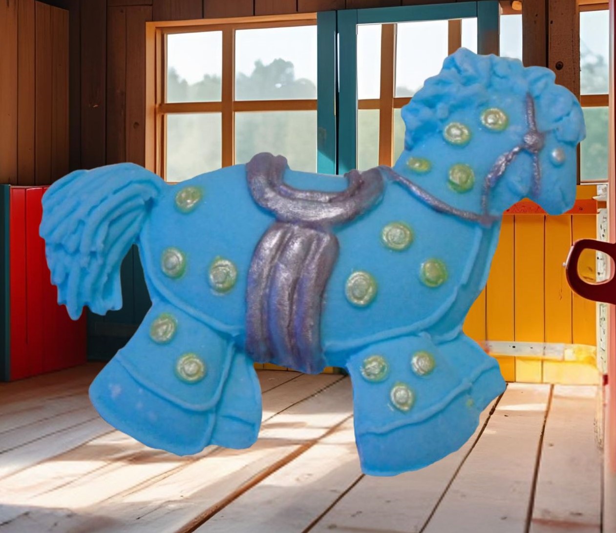 Blue hobby horse with colorful polka dots cake decorations image show it in a wooden room