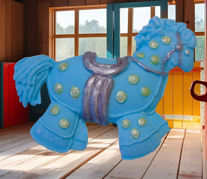 Blue hobby horse with colorful polka dots cake decorations image show it in a wooden room