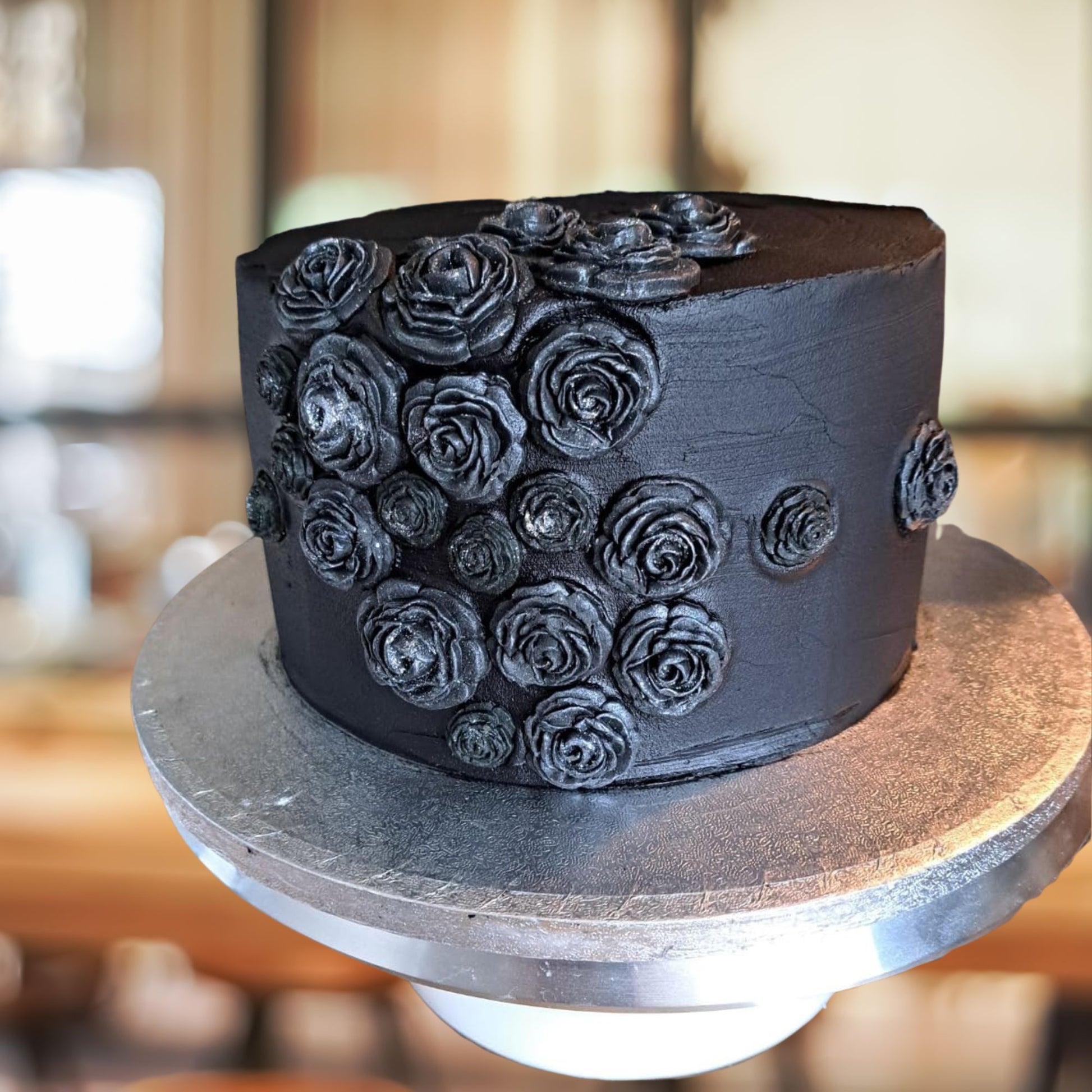 Customers black cake decorated with black littered roses