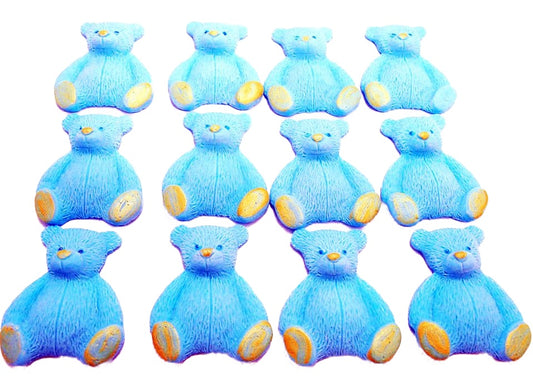 A set of blue edible teddy bear cupcake toppers arranged in rows on a white background