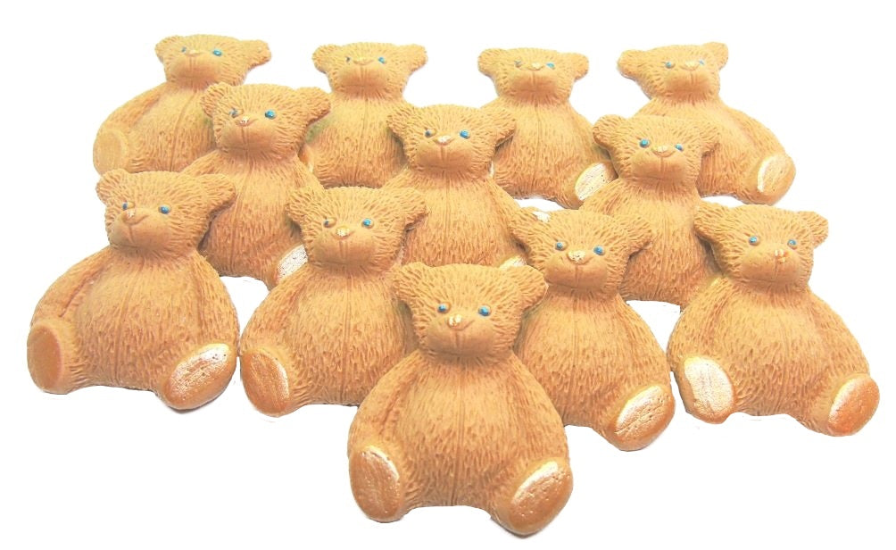 A set of  brown edible teddy bear cupcake toppers arranged in rows on a white background