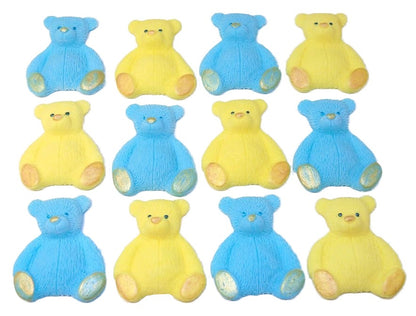 A set of blue and yellow edible teddy bear cupcake toppers arranged in rows on a white background