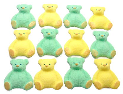 A set of green and yellow edible teddy bear cupcake toppers arranged in rows on a white background