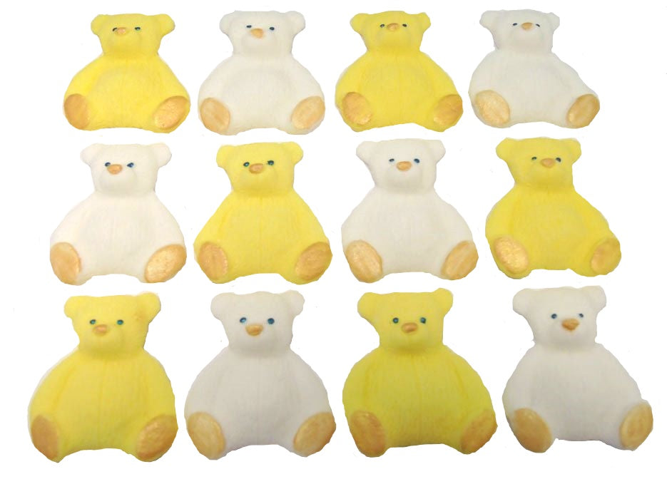 A set of yellow and white edible teddy bear cupcake toppers arranged in rows on a white background