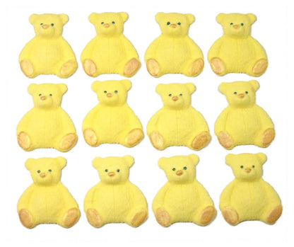 A set of yellow edible teddy bear cupcake toppers arranged in rows on a white background