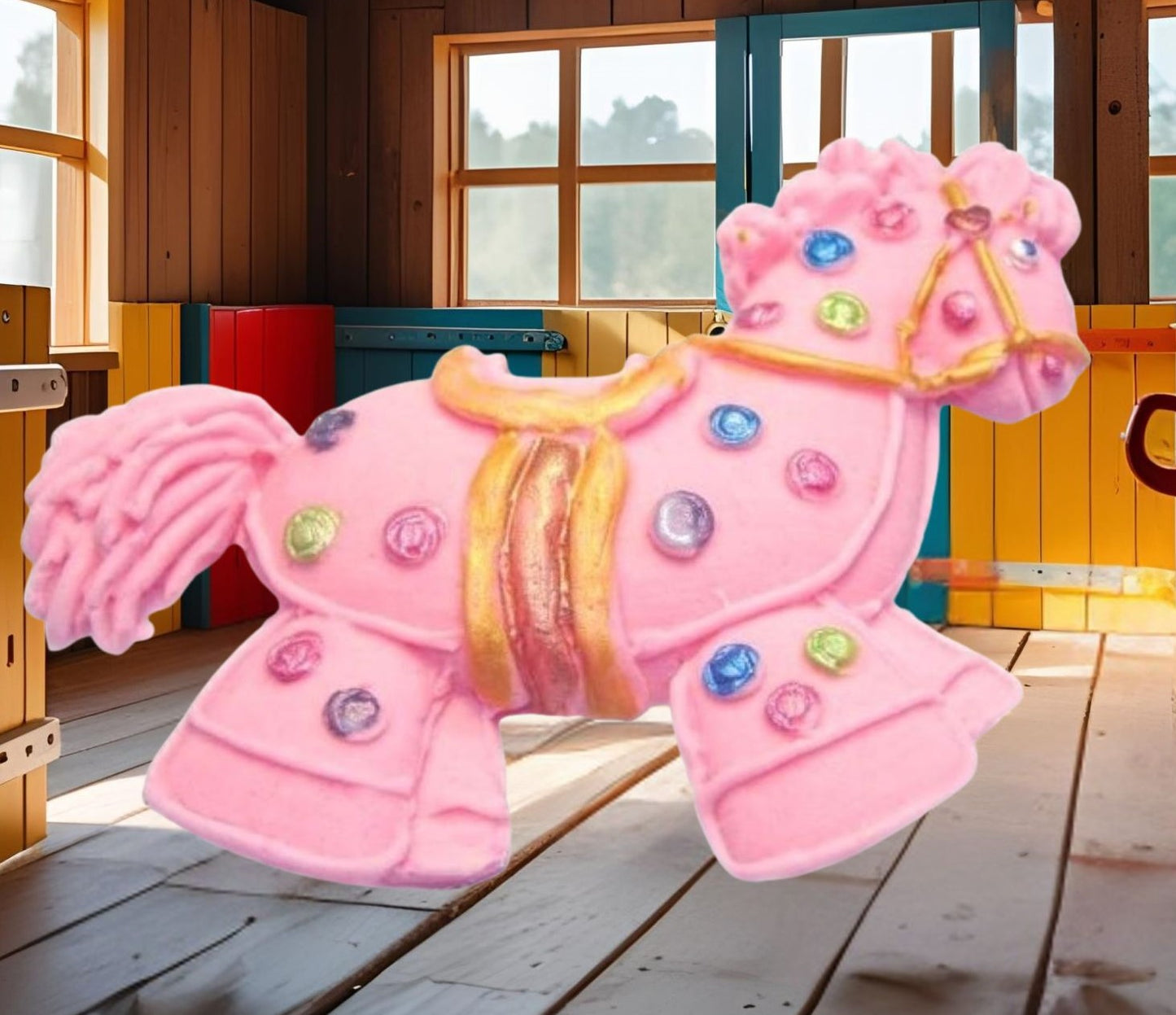 Pink hobby horse with colorful polka dots cake decorations image show it in a wooden room