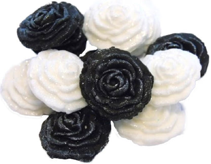 A collection of handmade edible glittered rose cupcake toppers in Black and White