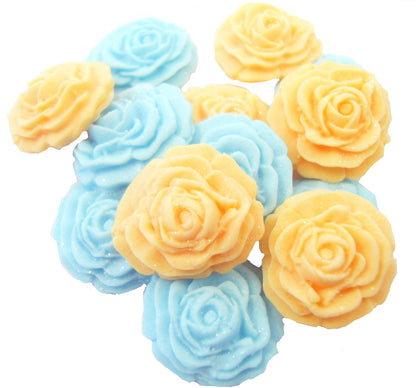 A collection of handmade edible glittered rose cupcake toppers in Blue and Peach