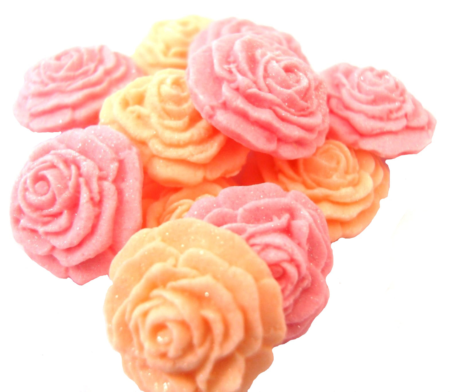 A collection of handmade edible glittered rose cupcake toppers in Peach and Pink