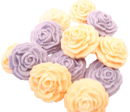 A collection of handmade edible glittered rose cupcake toppers in Peach and purple