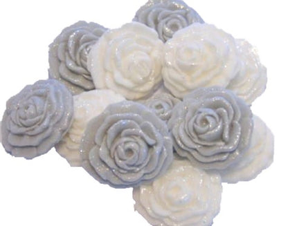 A collection of handmade edible glittered rose cupcake toppers in Silver and white