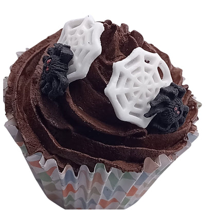 Chocolate cupcake with spiders on webs edible decorations on a white background