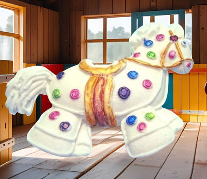 White hobby horse with colorful polka dots cake decorations image show it in a wooden room