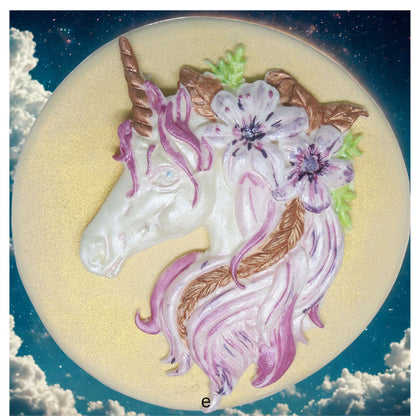 Unicorn with flowers cake decoration on a circular background with cloud background image