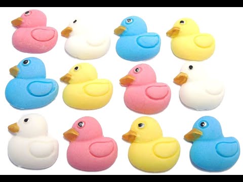 12 mix coloured ducks cupcake toppers ion a white background