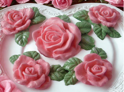 Close-up of a cake with red rose decorations on white plate