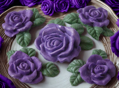 A set of edible glittered purple rose garland cake toppers with a large centre rose in a small basket, 